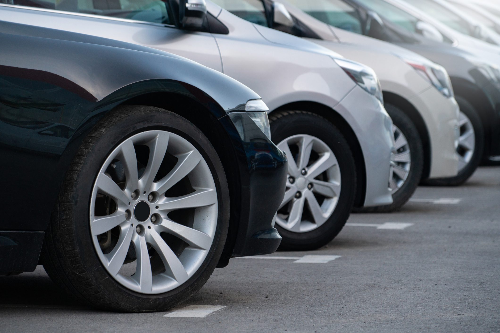 Row of parked cars in a lot.