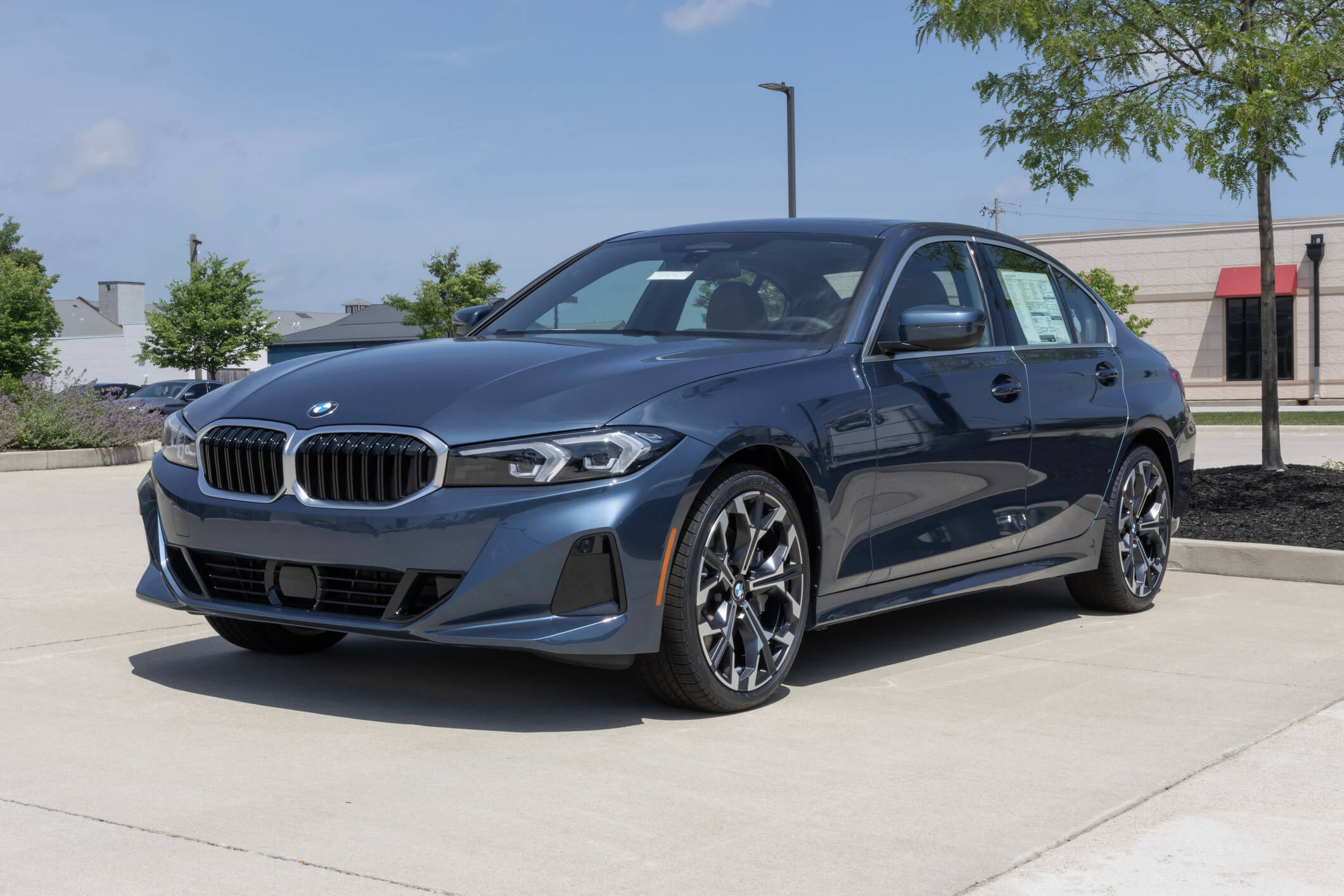 Blue BMW sedan parked in parking lot